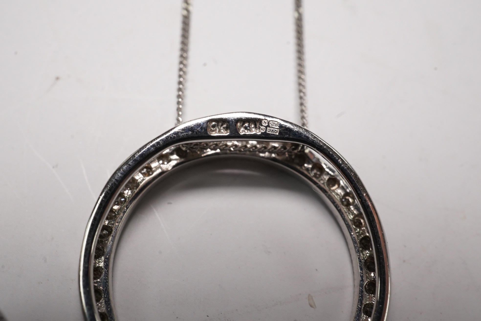 A modern 18k and diamond cluster set open work heart pendant, 25mm, a 9ct white gold and diamond chip set circular pendant necklace and o 9ct and Tahitian cultured pearl set pendant. Condition - fair to good